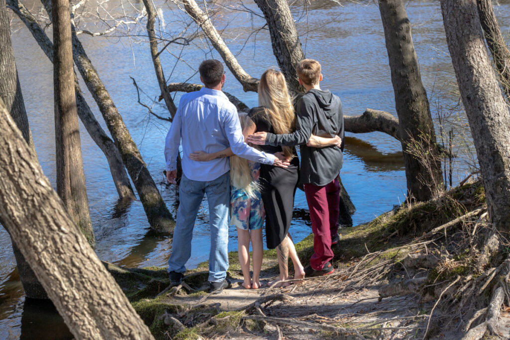 Jenny and her family on the shore of a river