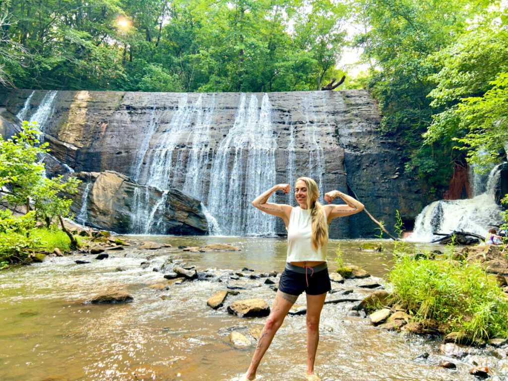 Jenny standing in front of a waterfall